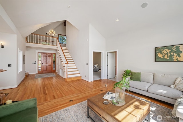 3851 Cliffside Dr, Bellingham, WA 98225 - living area with high vaulted ceiling, a chandelier, light wood finished floors, and stairs