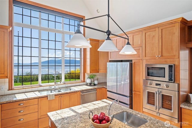 3851 Cliffside Dr, Bellingham, WA 98225 - kitchen with stainless steel appliances, decorative backsplash, lofted ceiling, pendant lighting, and a water view