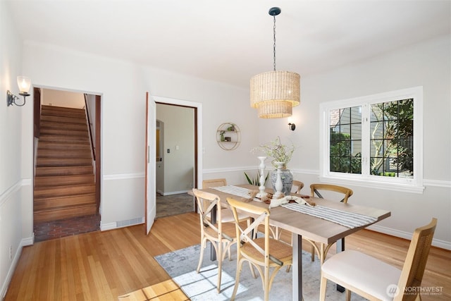 3851 Cliffside Dr, Bellingham, WA 98225 - dining area with light wood-style flooring, stairs, and a chandelier