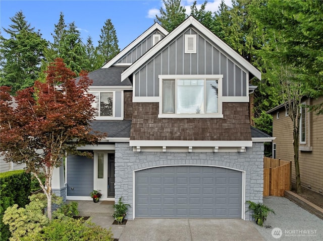 11832 158th Ave NE, Redmond, WA 98052 - view of front facade with roof with shingles, an attached garage, board and batten siding, driveway, and stone siding