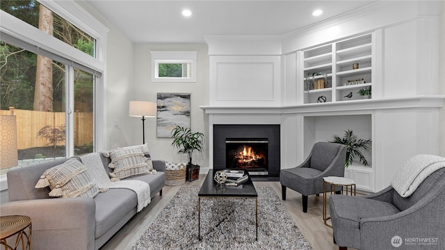 11832 158th Ave NE, Redmond, WA 98052 - living area with wood finished floors, a warm lit fireplace, recessed lighting, and built in features
