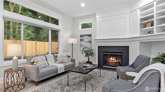 11832 158th Ave NE, Redmond, WA 98052 - living area with wood finished floors, a fireplace with flush hearth, and recessed lighting