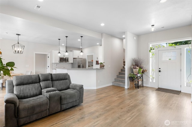 9386 Albert Way SE, Moses Lake, WA 98837 - living room featuring light wood finished floors, recessed lighting, stairway, and a chandelier