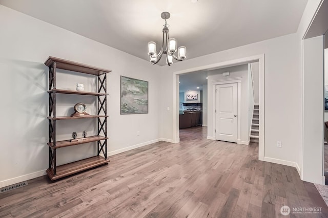3592 SE 16th St, North Bend, WA 98045 - empty room featuring a chandelier, wood finished floors, and stairs