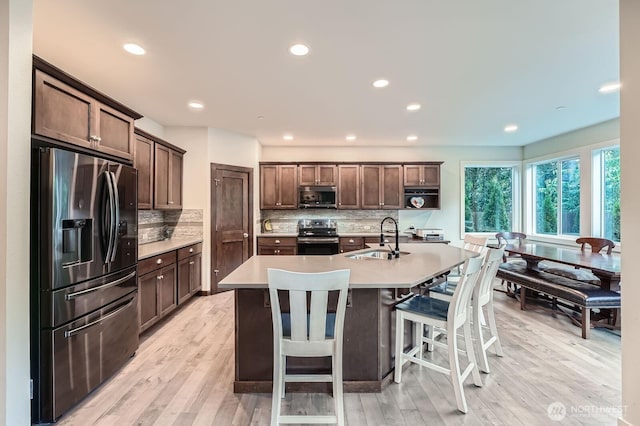 3592 SE 16th St, North Bend, WA 98045 - kitchen featuring stainless steel appliances, light countertops, tasteful backsplash, light wood-type flooring, and recessed lighting