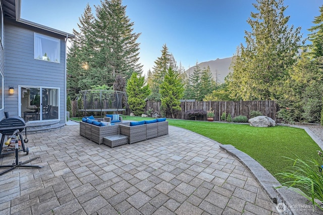 3592 SE 16th St, North Bend, WA 98045 - fenced backyard with a trampoline, a patio, and an outdoor hangout area