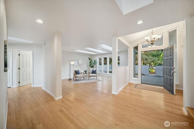 12 Jamestown Beach Ln, Sequim, WA 98382 - entryway featuring a skylight, a chandelier, light wood-style floors, and recessed lighting