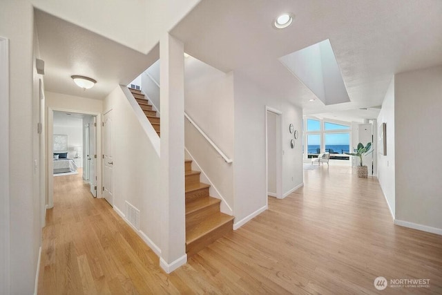 12 Jamestown Beach Ln, Sequim, WA 98382 - hallway featuring stairway, light wood finished floors, and recessed lighting