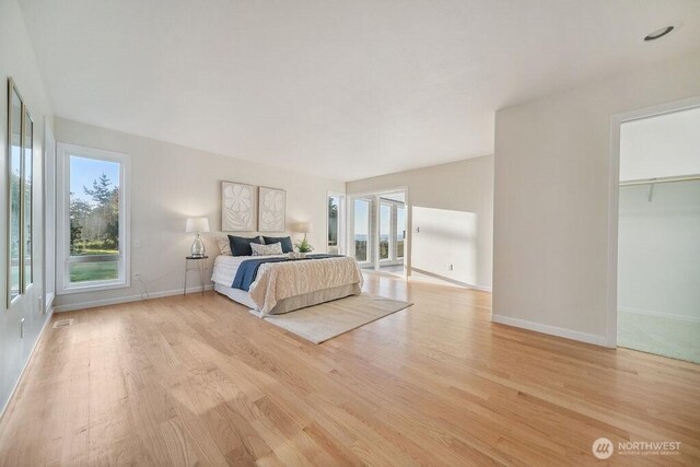 12 Jamestown Beach Ln, Sequim, WA 98382 - bedroom with light wood-style flooring and access to outside