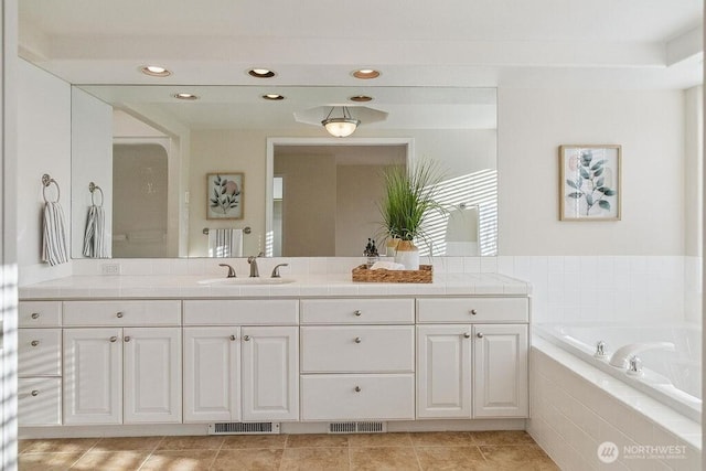 12 Jamestown Beach Ln, Sequim, WA 98382 - bathroom with double vanity, a garden tub, recessed lighting, and tile patterned flooring
