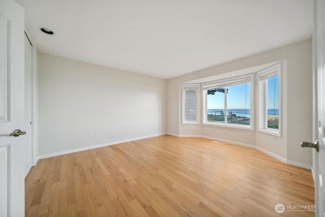12 Jamestown Beach Ln, Sequim, WA 98382 - unfurnished room with light wood-style floors and baseboards