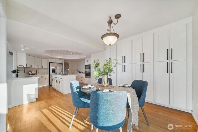 12 Jamestown Beach Ln, Sequim, WA 98382 - dining area featuring light wood-style flooring, a raised ceiling, and recessed lighting