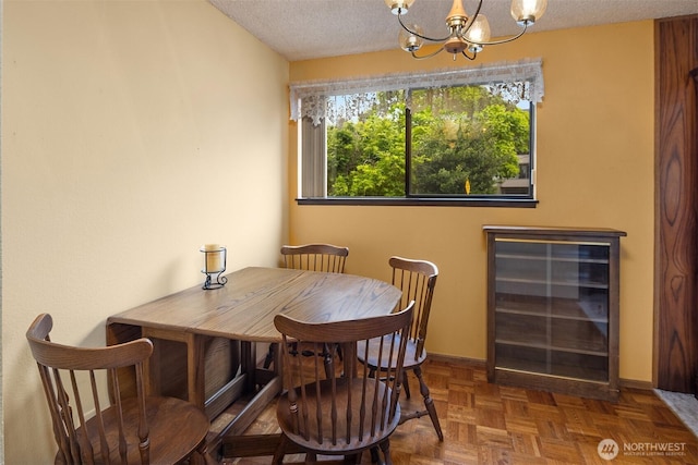 335 3rd Ave S Unit 203, Edmonds, WA 98020 - dining room featuring a chandelier, a textured ceiling, and wine cooler