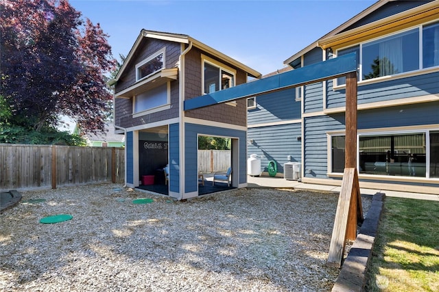 1132 121st St E, Tacoma, WA 98445 - rear view of property with a fenced backyard and a patio area