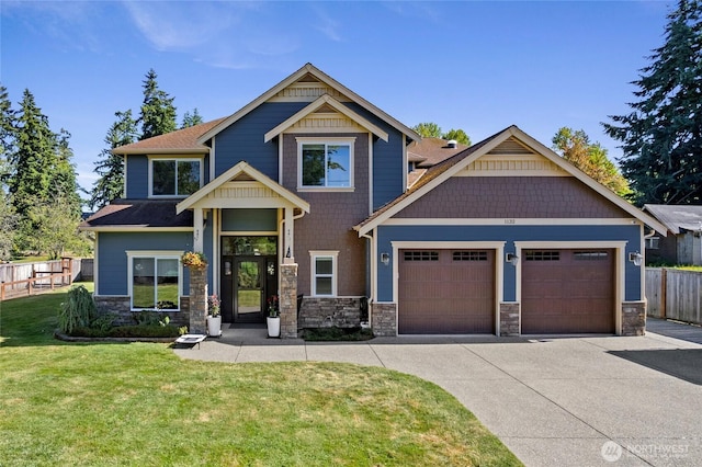 1132 121st St E, Tacoma, WA 98445 - craftsman inspired home featuring an attached garage, concrete driveway, and stone siding