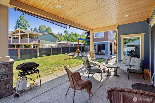 1132 121st St E, Tacoma, WA 98445 - fenced backyard featuring grilling area, a patio, and an outdoor living space with a fire pit