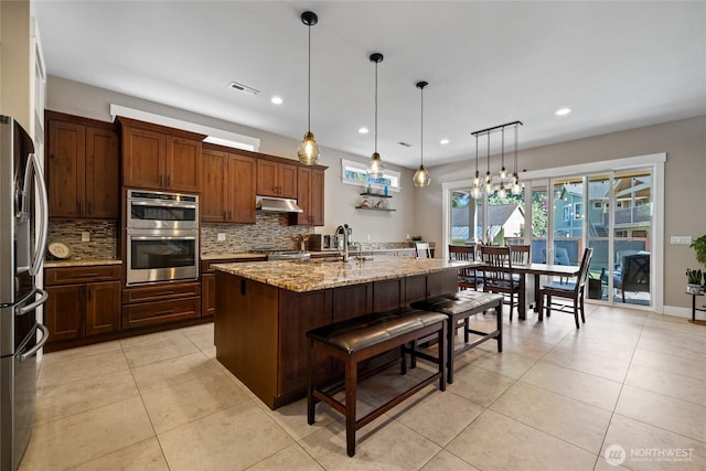 1132 121st St E, Tacoma, WA 98445 - kitchen with appliances with stainless steel finishes, tasteful backsplash, light tile patterned flooring, light stone counters, and recessed lighting