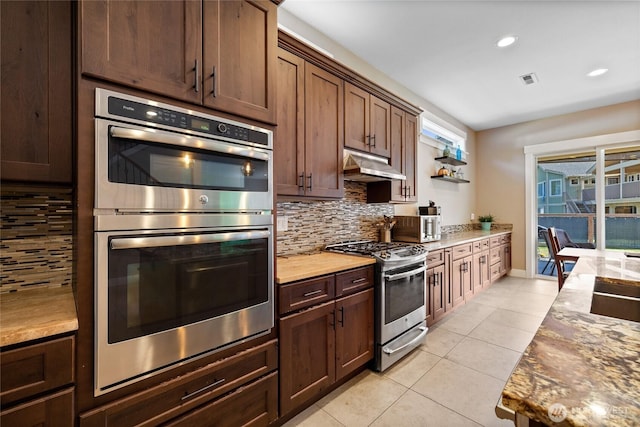 1132 121st St E, Tacoma, WA 98445 - kitchen featuring stainless steel appliances, light tile patterned flooring, backsplash, under cabinet range hood, and recessed lighting