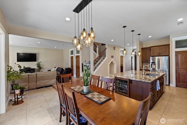 1132 121st St E, Tacoma, WA 98445 - dining area featuring light tile patterned floors, stairway, recessed lighting, and beverage cooler