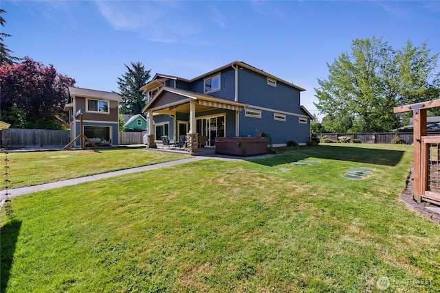 1132 121st St E, Tacoma, WA 98445 - rear view of house with a hot tub, a fenced backyard, and a patio