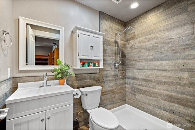 1132 121st St E, Tacoma, WA 98445 - bathroom featuring tiled shower, vanity, and tile walls