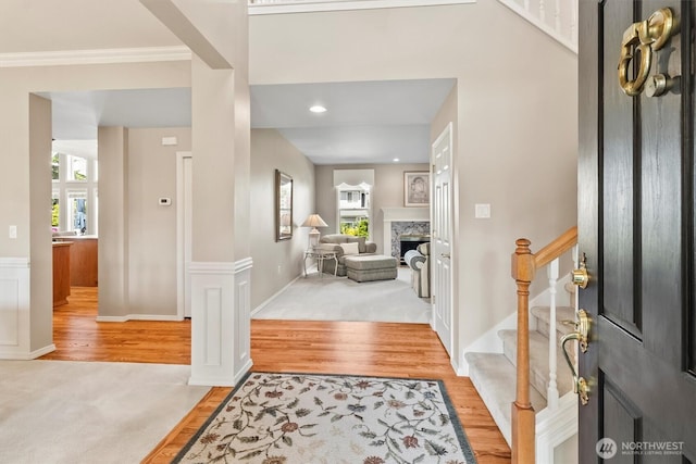 3819 Ridge Ct, Mount Vernon, WA 98274 - entrance foyer with stairway, light wood-style flooring, light carpet, a high end fireplace, and ornamental molding