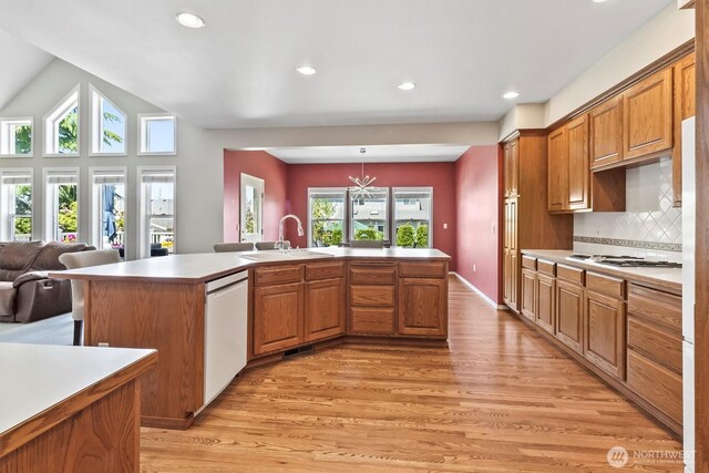 3819 Ridge Ct, Mount Vernon, WA 98274 - kitchen featuring white appliances, light wood-style flooring, brown cabinets, recessed lighting, and backsplash