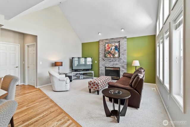 3819 Ridge Ct, Mount Vernon, WA 98274 - living room with high vaulted ceiling, a fireplace, wood finished floors, recessed lighting, and carpet floors