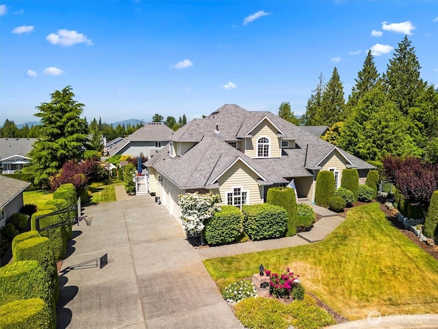 3819 Ridge Ct, Mount Vernon, WA 98274 - traditional-style home featuring a garage, concrete driveway, a front lawn, and a shingled roof
