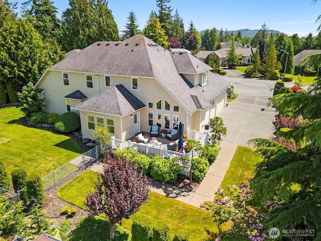 3819 Ridge Ct, Mount Vernon, WA 98274 - back of house with an outdoor hangout area, a fenced backyard, roof with shingles, concrete driveway, and a deck with mountain view