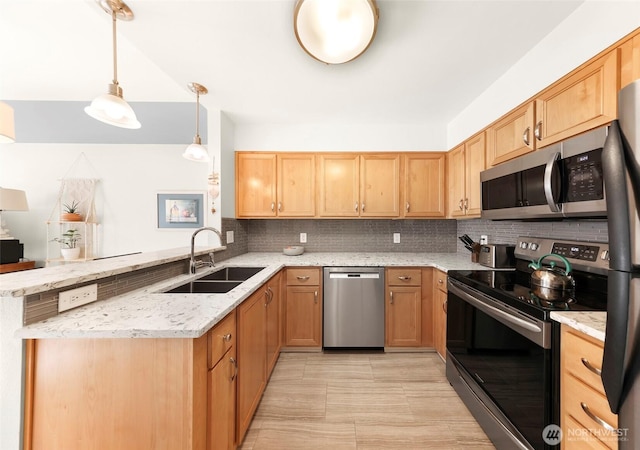 910 Harris Ave Unit 304, Bellingham, WA 98225 - kitchen featuring appliances with stainless steel finishes, a peninsula, backsplash, and light stone counters