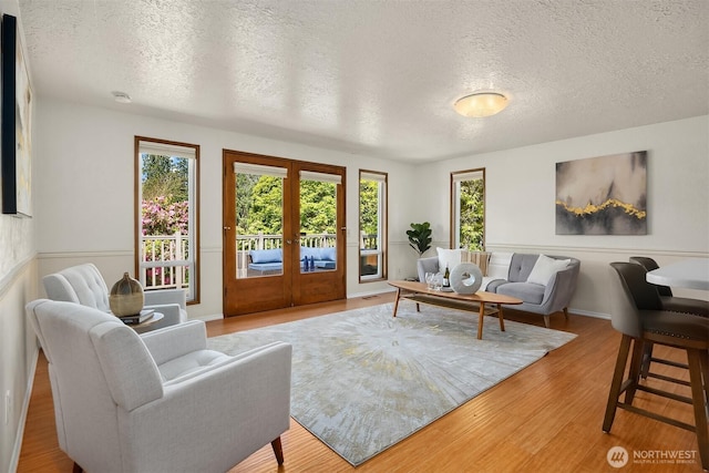 9119 185th Pl SW, Edmonds, WA 98026 - living room featuring french doors, a textured ceiling, and wood finished floors