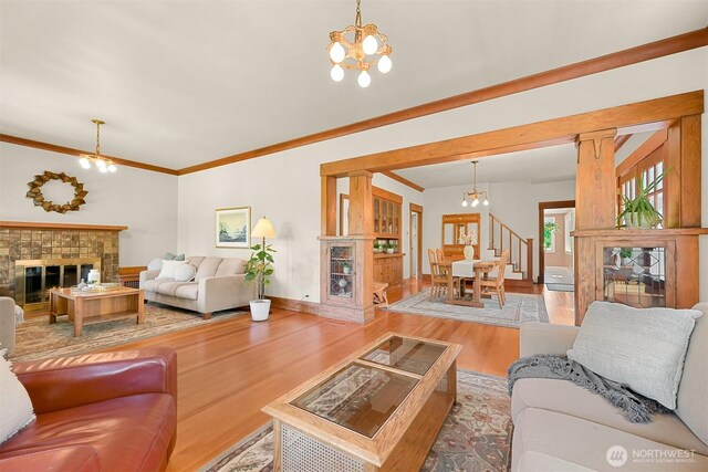 1800 Dakin St, Bellingham, WA 98229 - living room with a chandelier, wood finished floors, a glass covered fireplace, and crown molding