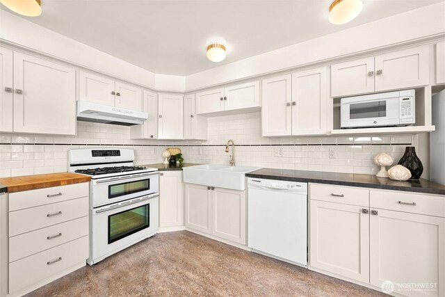 1800 Dakin St, Bellingham, WA 98229 - kitchen featuring white appliances, under cabinet range hood, decorative backsplash, and white cabinetry