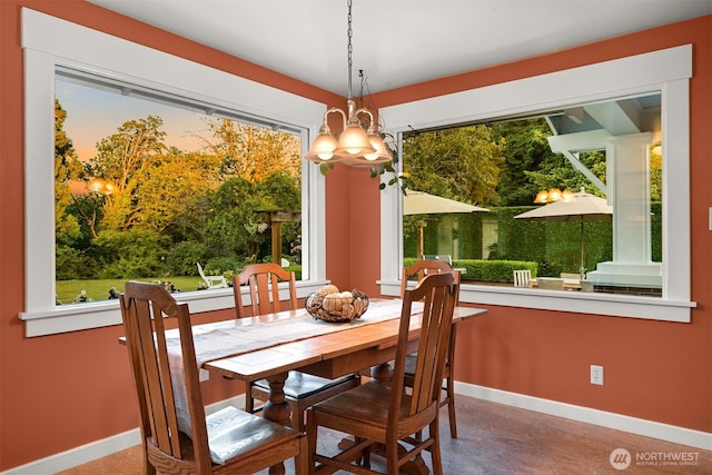 1800 Dakin St, Bellingham, WA 98229 - dining room featuring a chandelier, concrete flooring, and plenty of natural light