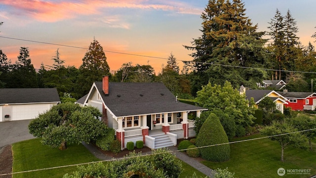 1800 Dakin St, Bellingham, WA 98229 - view of front of home with a porch, a chimney, an outdoor structure, a garage, and a lawn