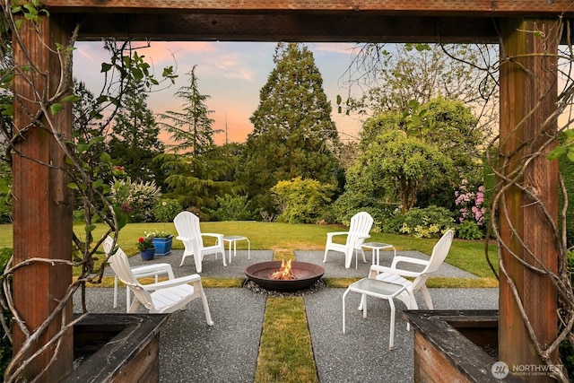 1800 Dakin St, Bellingham, WA 98229 - patio terrace at dusk with an outdoor fire pit, a patio area, and a lawn