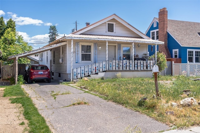 229 N Garfield Ave, Wenatchee, WA 98801 - view of front of home featuring covered porch, a metal roof, and asphalt driveway