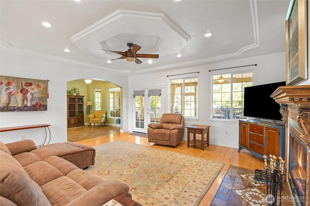 7322 NE Blue Goose Rd, Moses Lake, WA 98837 - living area with arched walkways, healthy amount of natural light, recessed lighting, ceiling fan, and a tray ceiling