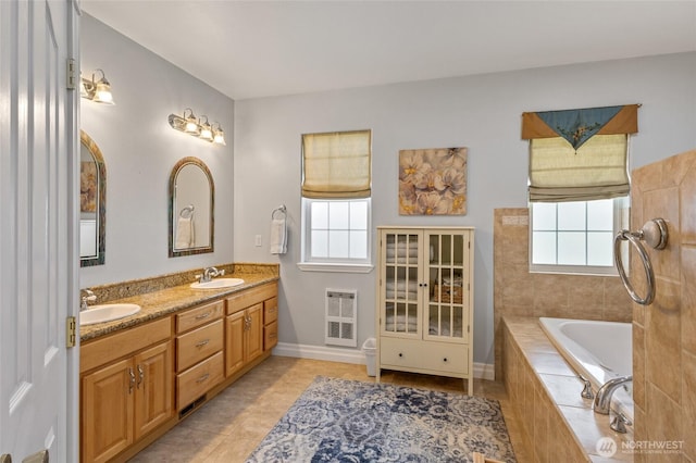 7322 NE Blue Goose Rd, Moses Lake, WA 98837 - bathroom featuring plenty of natural light, double vanity, a garden tub, and tile patterned flooring