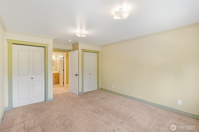7322 NE Blue Goose Rd, Moses Lake, WA 98837 - unfurnished bedroom with two closets, light carpet, and ornamental molding