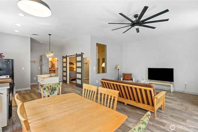 7322 NE Blue Goose Rd, Moses Lake, WA 98837 - dining area with a barn door, a ceiling fan, wood finished floors, and recessed lighting