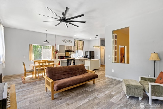 7322 NE Blue Goose Rd, Moses Lake, WA 98837 - living area featuring light wood finished floors, a ceiling fan, and recessed lighting