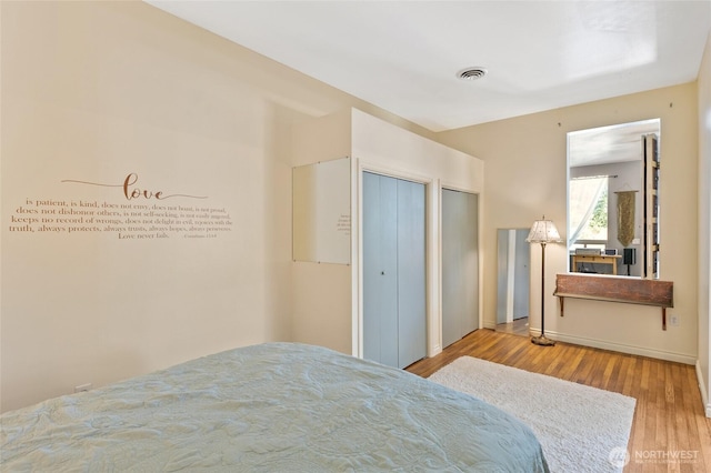 7322 NE Blue Goose Rd, Moses Lake, WA 98837 - bedroom with wood finished floors and two closets