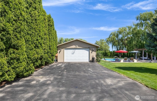 7322 NE Blue Goose Rd, Moses Lake, WA 98837 - view of front of property featuring a garage, an outbuilding, an outdoor pool, a pergola, and a front lawn