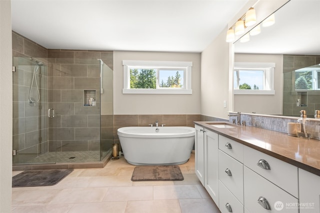 8704 188th St SW, Edmonds, WA 98026 - bathroom featuring healthy amount of natural light, vanity, a stall shower, a soaking tub, and tile walls