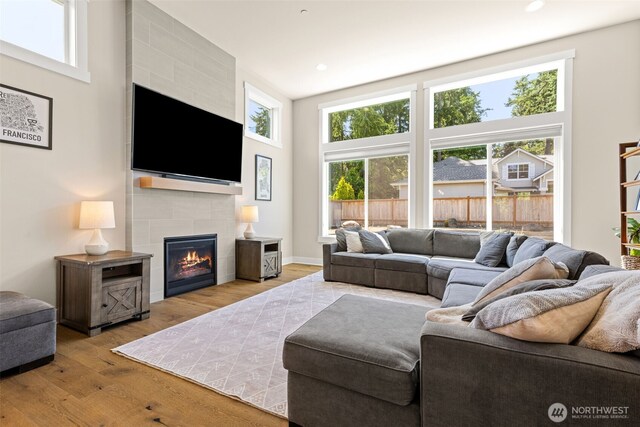 8704 188th St SW, Edmonds, WA 98026 - living room with wood finished floors, plenty of natural light, a fireplace, recessed lighting, and a high ceiling