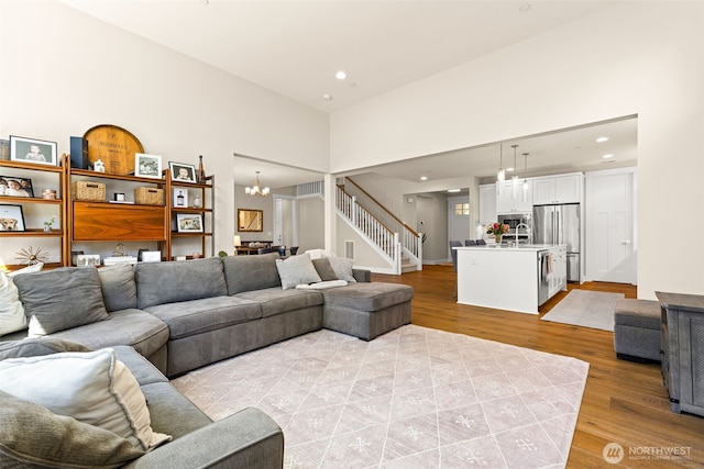 8704 188th St SW, Edmonds, WA 98026 - living area featuring a chandelier, light wood finished floors, recessed lighting, stairway, and a towering ceiling