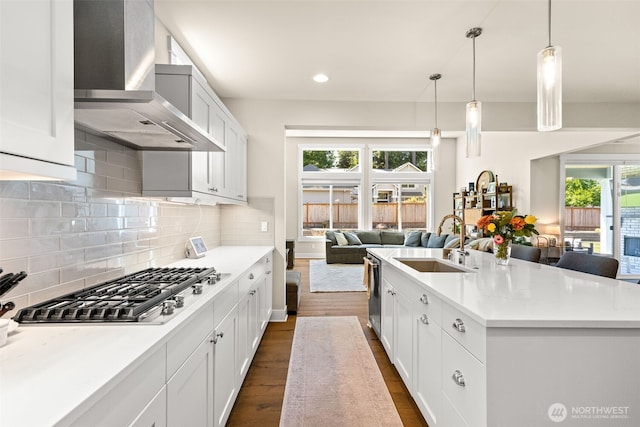 8704 188th St SW, Edmonds, WA 98026 - kitchen featuring wall chimney exhaust hood, open floor plan, appliances with stainless steel finishes, dark wood-style floors, and plenty of natural light