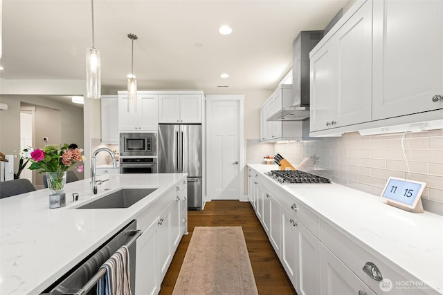 8704 188th St SW, Edmonds, WA 98026 - kitchen featuring appliances with stainless steel finishes, wall chimney exhaust hood, dark wood-style floors, hanging light fixtures, and white cabinets